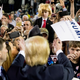 The real Donald Trump gestures to a 5-year-old dressed up as him at a rally in Georgia (AP Photo/Andrew Harnik)